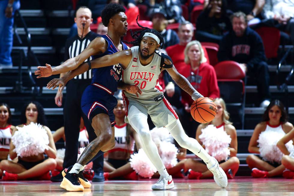 UNLV Rebels forward Keylan Boone (20) pressures his way toward the hoop against Fresno State Bu ...