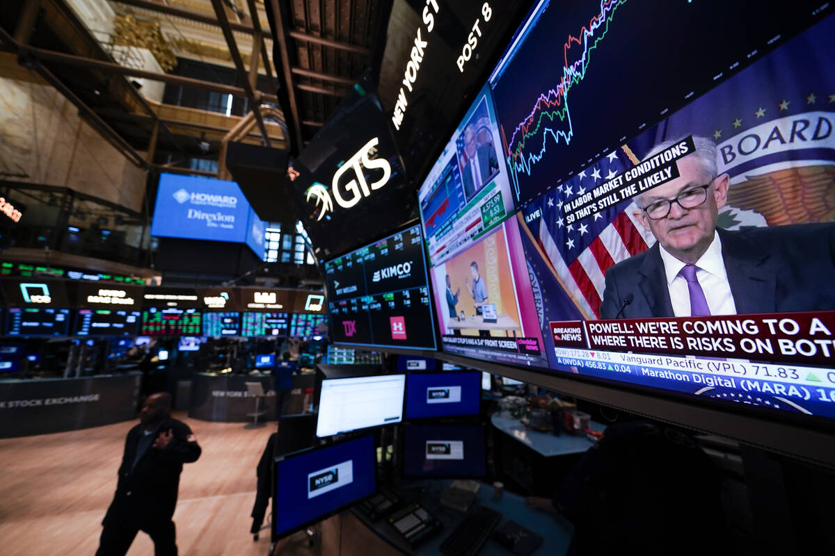 Federal Reserve Chairman Jerome Powell appears on a video monitor on the floor at the New York ...