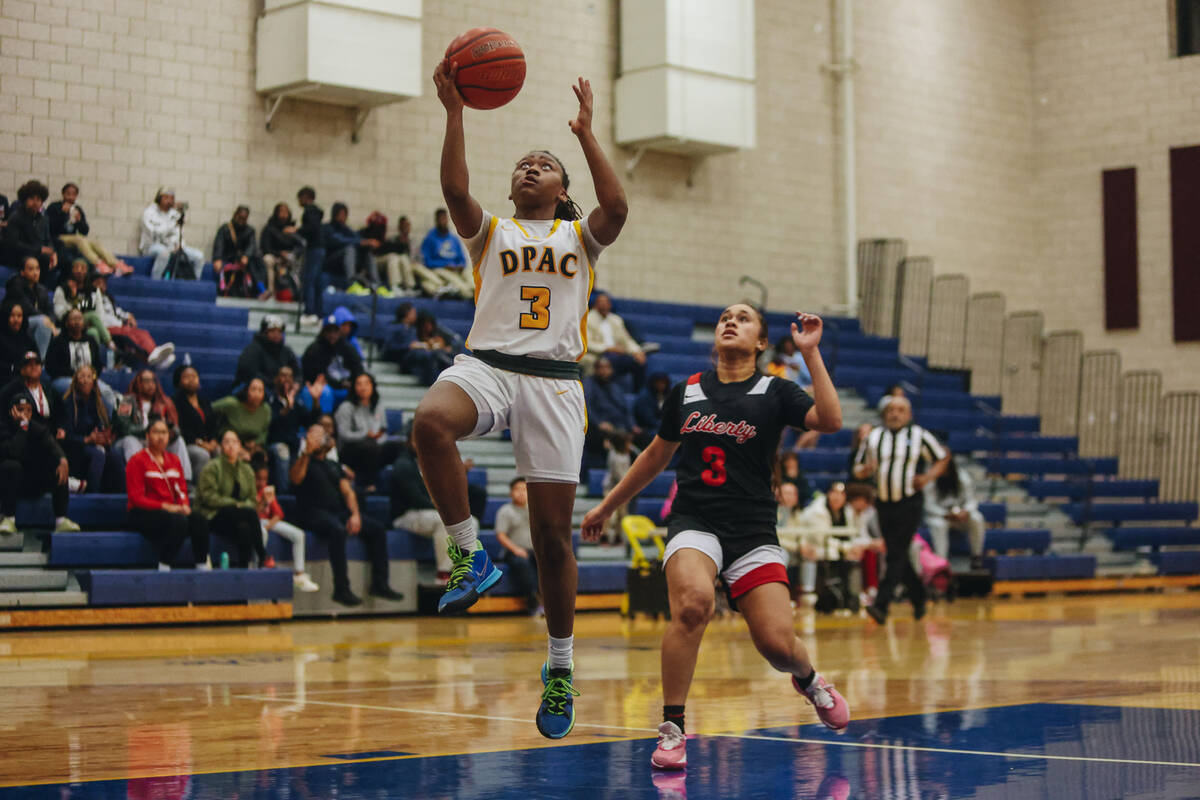 Democracy Prep’s Bray’ana Miles (3) attempts a layup during a basketball game bet ...