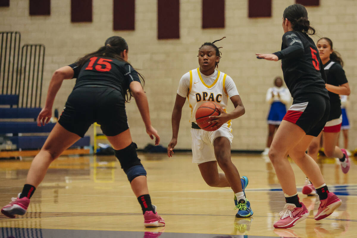 Democracy Prep’s Bray’ana Miles (3) drives the ball to the hoop during a basketba ...