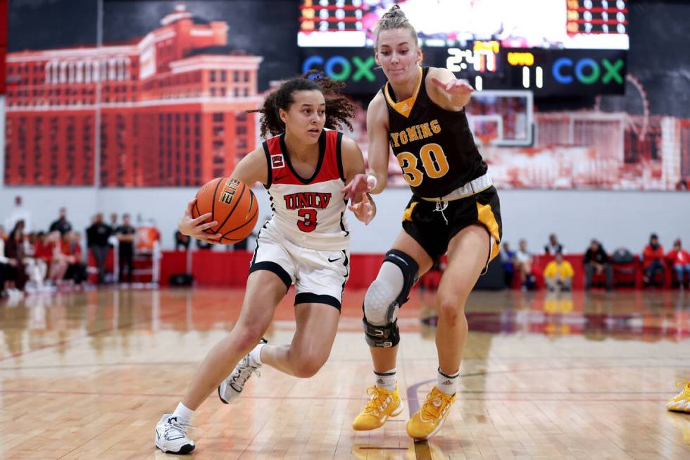 UNLV Lady Rebels guard Kiara Jackson (3) drives toward the hoop against Wyoming Cowgirls guard ...