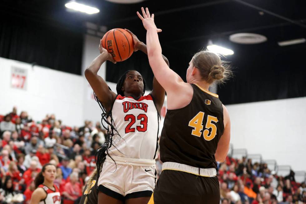 UNLV Lady Rebels center Desi-Rae Young (23) shoots against Wyoming Cowgirls center Allyson Fert ...