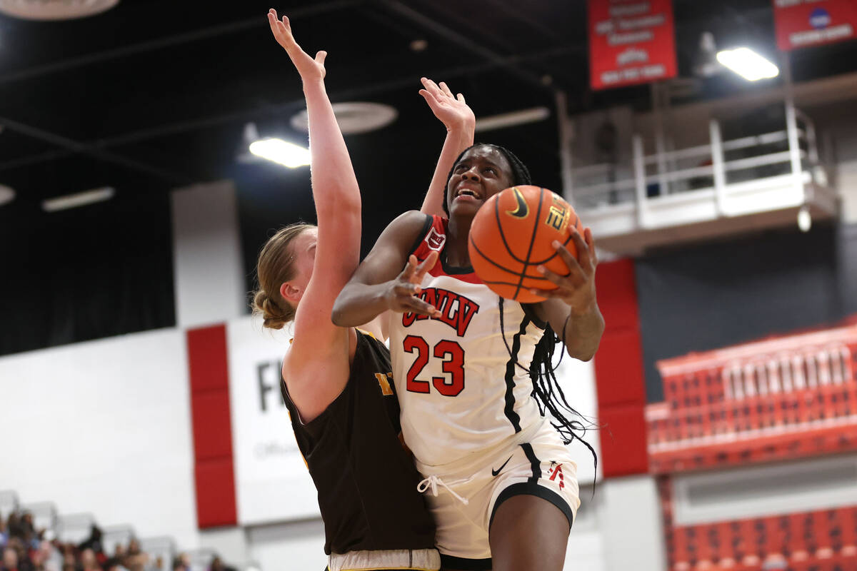 UNLV Lady Rebels center Desi-Rae Young (23) muscles toward the hoop against Wyoming Cowgirls ce ...