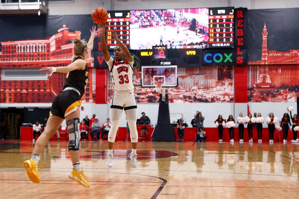 UNLV Lady Rebels guard Amarachi Kimpson (33) shoots against Wyoming Cowgirls guard Ola Ustowska ...