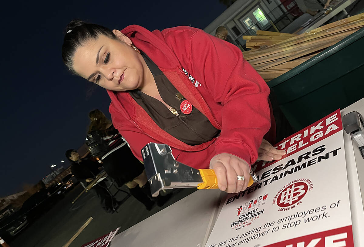 Culinary Local 226 member Mercie Gonzalez prepares strike signs at the union's headquarters on ...