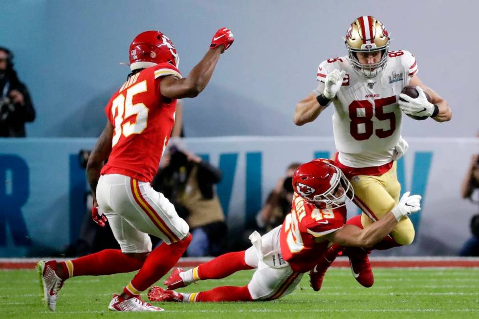 San Francisco 49ers' George Kittle (85) runs against Kansas City Chiefs' Daniel Sorensen (49) a ...