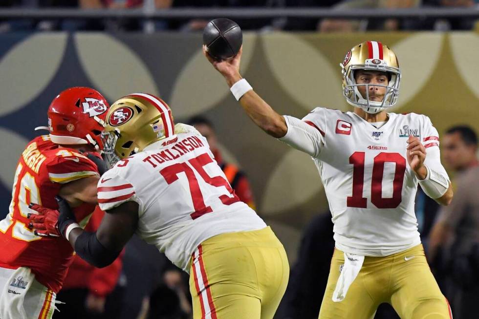 San Francisco 49ers' quarterback Jimmy Garoppolo passes under pressure from Kansas City Chiefs' ...