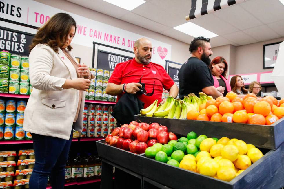 People mingle at the grand opening of the Just One Project’s community market at Mojave ...