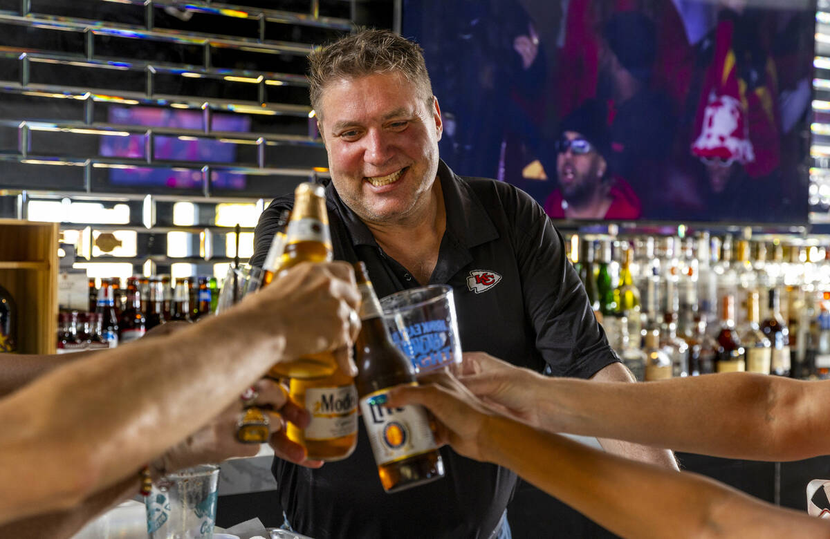 The Jackpot Bar owner Jeff Frederick toasts with members of the KC CHIEFS - Las Vegas Kingdom g ...