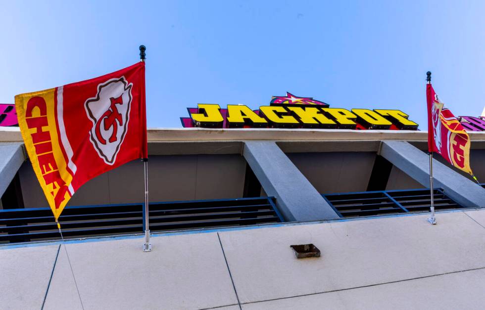 Kansas City Chiefs flags hang outside the Jackpot Bar which features members of the KC CHIEFS - ...
