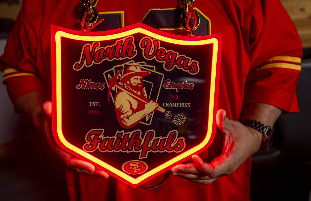 Gaston Larsen shows off his custom sign as a member of the North Vegas Faithfuls, a San Francis ...