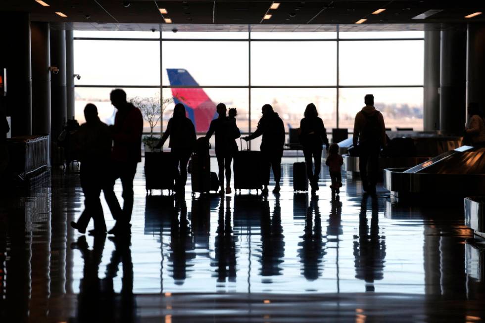 FILE - People pass through Salt Lake City International Airport Wednesday, Jan. 11, 2023, in Sa ...