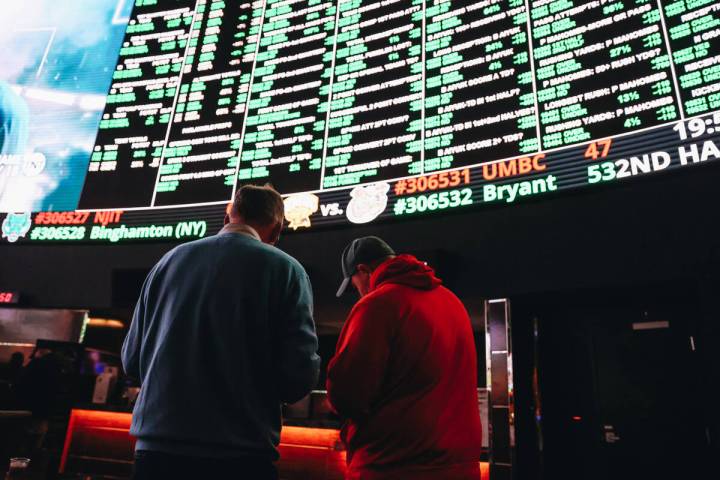 Bettors take notes on a menu of Super Bowl props at the Westgate SuperBook on Thursday, Feb. 1, ...