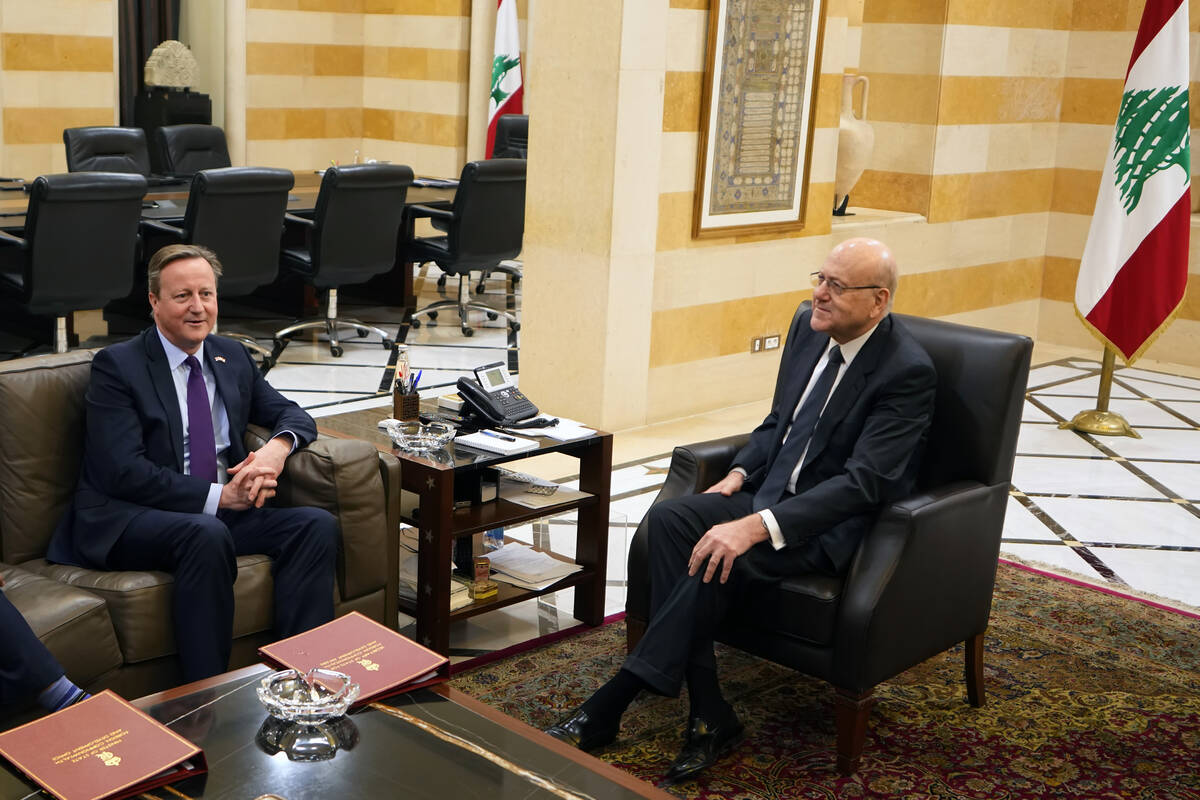 Britain's Foreign Secretary David Cameron, left, meets with Lebanese caretaker Prime Minister N ...
