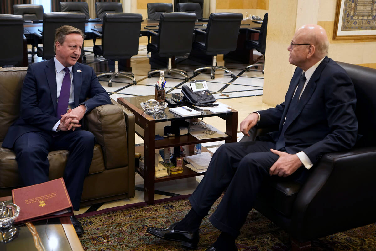 Britain's Foreign Secretary David Cameron, left, meets with Lebanese caretaker Prime Minister N ...