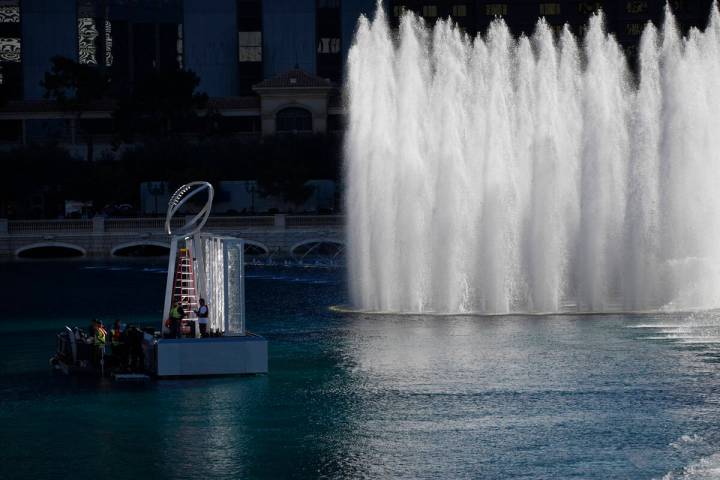 Workers erect a Lombardi Trophy statue at the Bellagio fountains ahead of the Super Bowl 58 foo ...