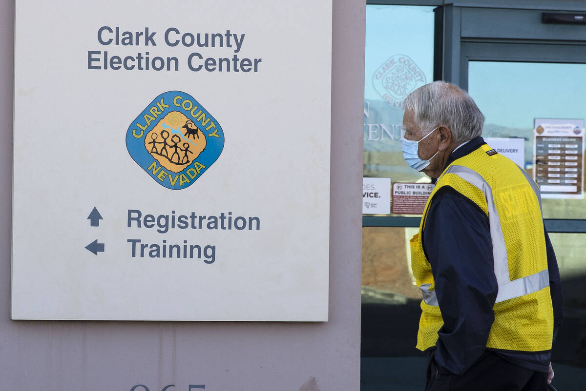 FILE - A security guard walks outside of the Clark County Election Center on Wednesday, Nov. 4, ...