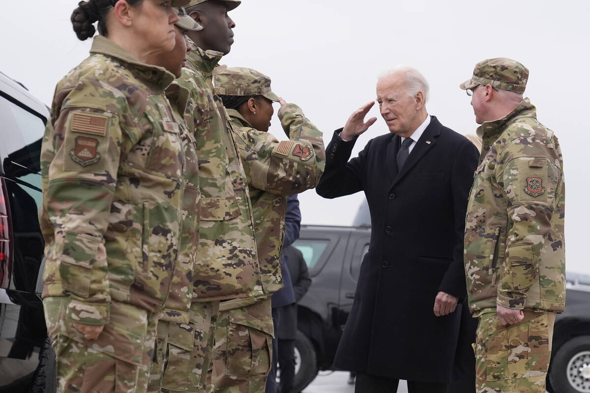 President Joe Biden greets service members after arriving at Dover Air Force Base, Del., Friday ...