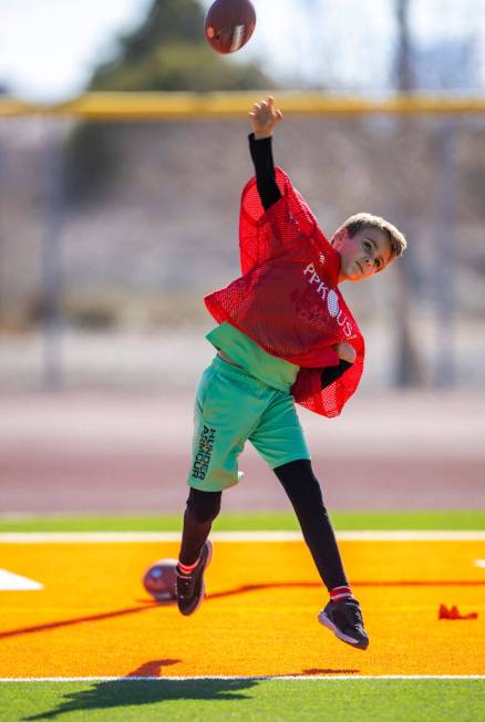 Jason Hart of Las Vegas, an 8/9-year-old boy's contestant, throws the ball during the Punt, Pas ...