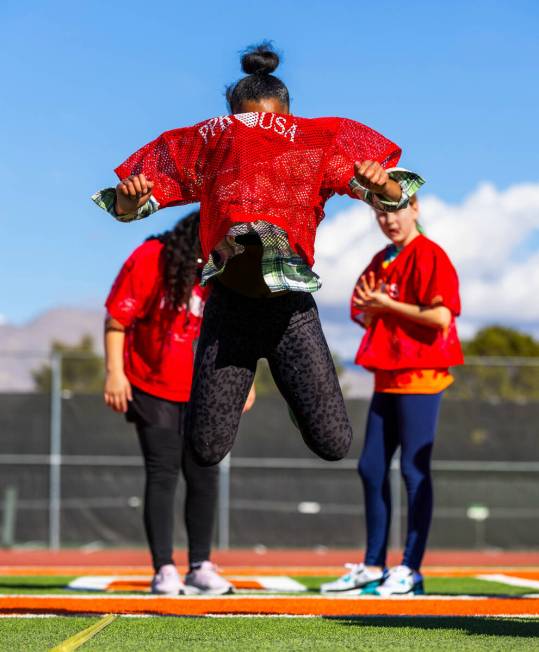 G’Justice Owens of Las Vegas, a 10/11-year-old girl's contestant, leaps in a standing br ...