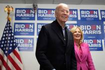 President Joe Biden, left, waits to speak as first lady Jill Biden looks on at the Biden campai ...