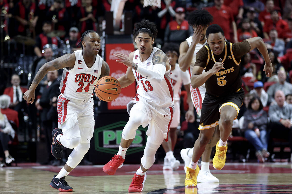 UNLV Rebels guard Brooklyn Hicks (13) drives up the court followed by guard Jackie Johnson III ...
