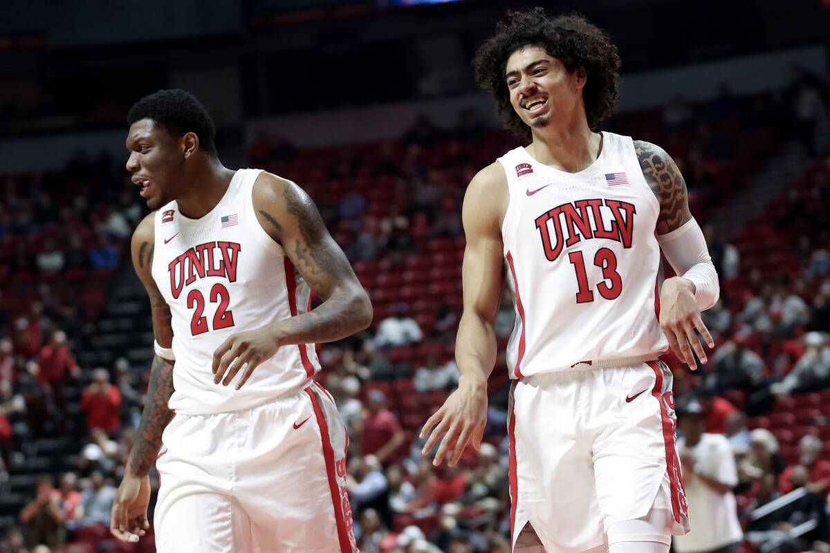 UNLV Rebels forward Karl Jones (22) and guard Brooklyn Hicks (13) celebrate as they head into a ...