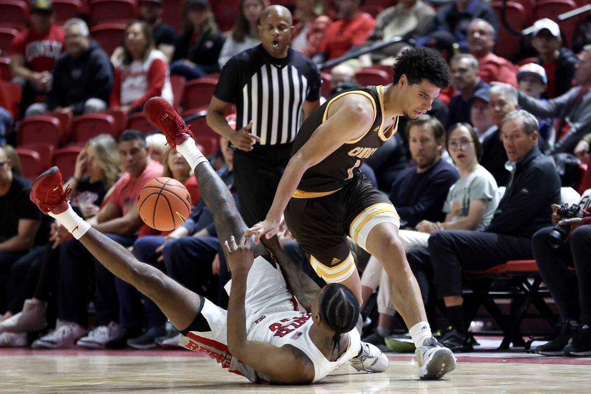 Wyoming Cowboys guard Brendan Wenzel (1) commits an offensive foul on UNLV Rebels guard Luis Ro ...