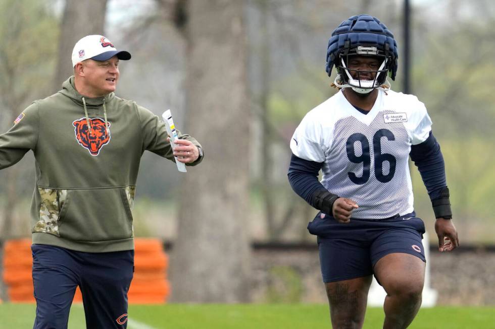 Chicago Bears offensive coordinator Luke Getsy, left, talks to Chicago Bears 2023 draft pick, d ...