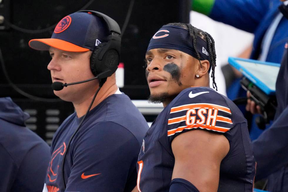 Chicago Bears quarterback Justin Fields sits on the bench with Offensive Coordinator Luke Getsy ...