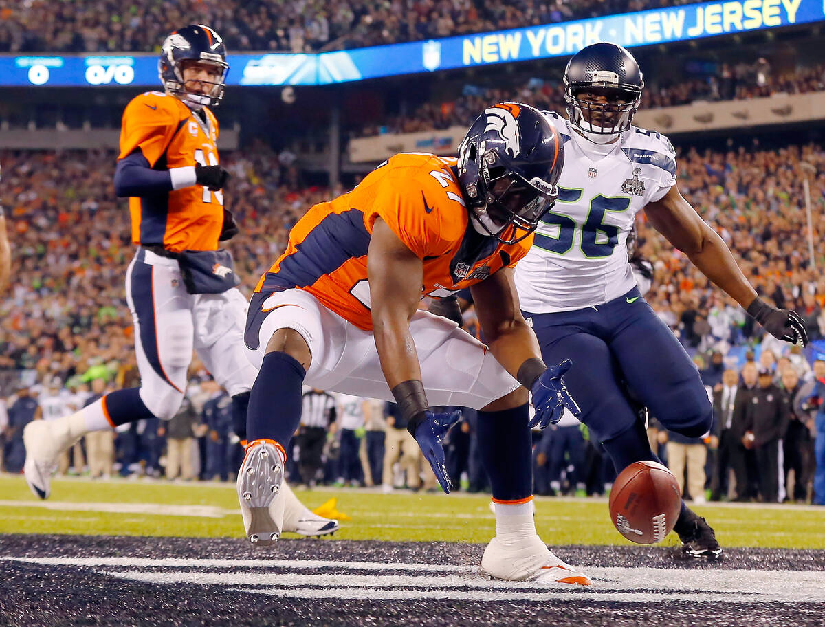 Denver Broncos Knowshon Moreno reaches for a loose ball in the end zone after the snap sailed p ...