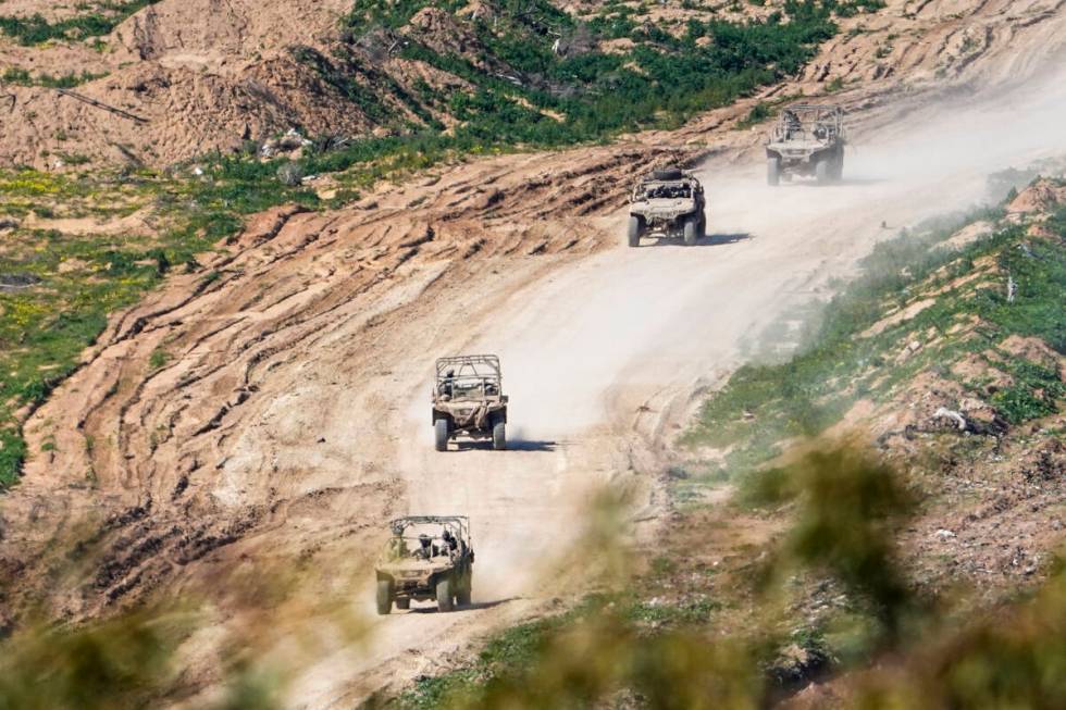 Israeli soldiers drive in the Gaza Strip, as seen from southern Israel, Sunday, Feb. 4, 2024. T ...