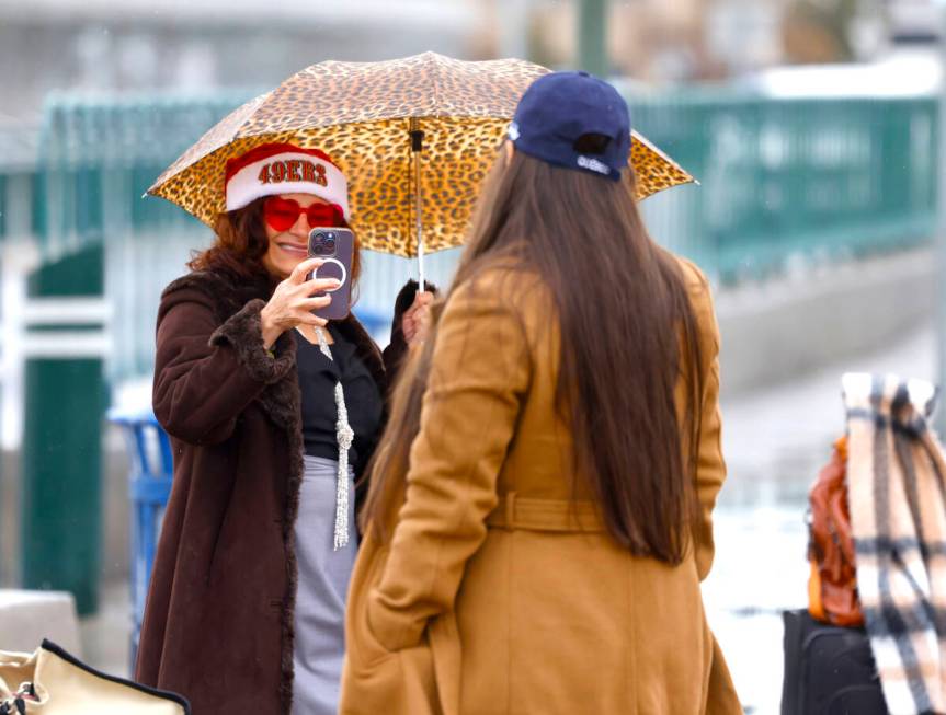 Nelly Gutierrez of San Jose, Calf., left, takes a photo of her friend Alejandro Soto near the & ...