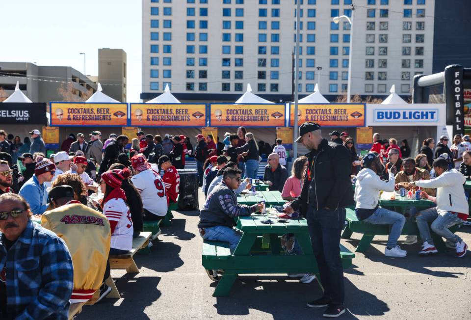 Crowds eat and order food at Guy’s Flavortown Tailgate party for Super Bowl LVIII at a p ...