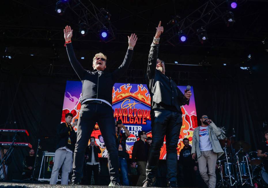 Celebrity chefs Gordon Ramsey, left, and Guy Fieri, right, gesture after Ramsey threw a footbal ...