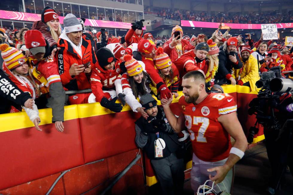 Kansas City Chiefs tight end Travis Kelce (87) celebrates with fans as he walks off the field a ...