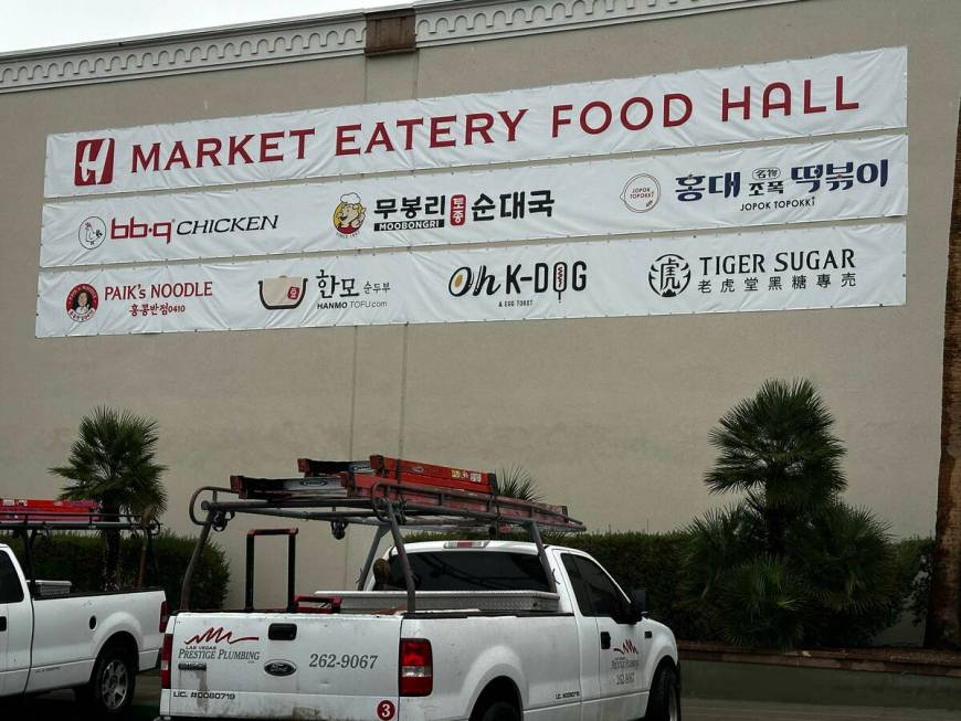 A banner that lists the tenants of the H Mart food hall which will be located in the Korean gro ...