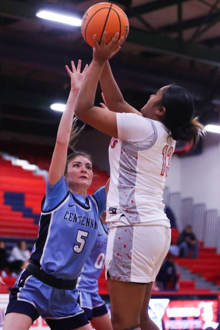 Liberty’s Aiyanna Eteuini (13) takes a shot while Centennial’s Trysta Barrett (5) ...