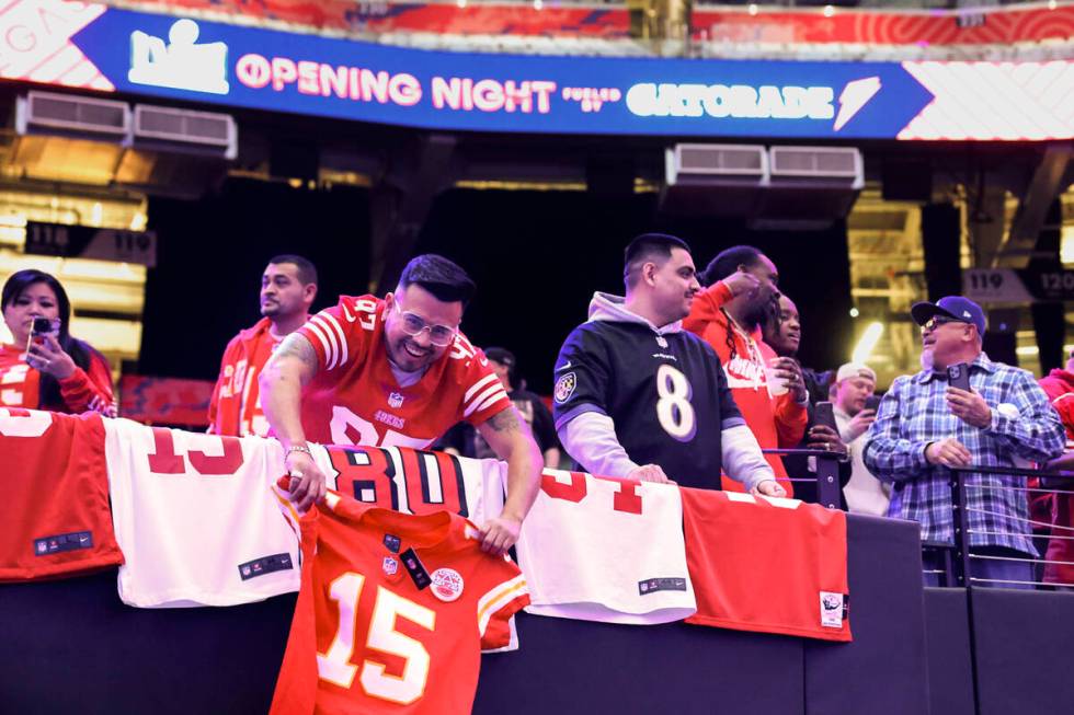 San Francisco 49ers fans snag T-shirts during Super Bowl Opening Night festivities at Allegiant ...