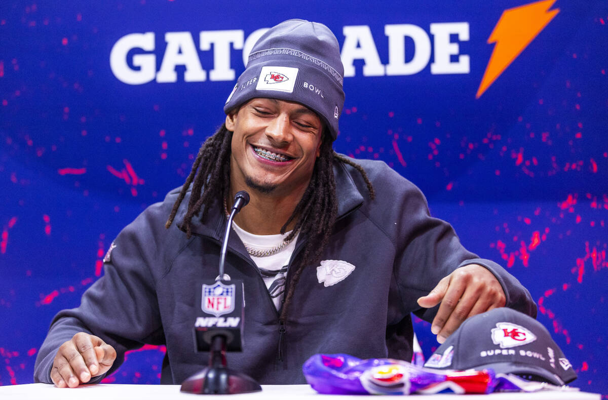 Kansas City Chiefs player Isiah Pacheco smiles at a media member's question on the field during ...