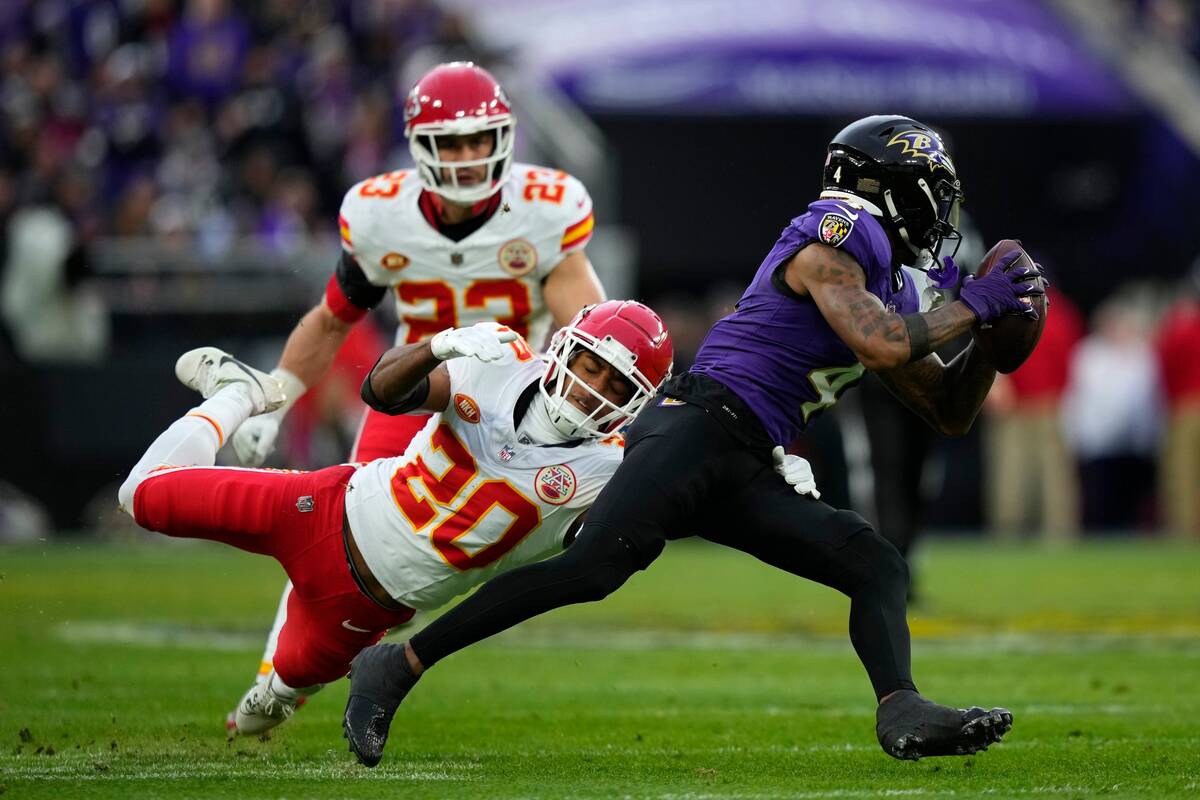 Baltimore Ravens wide receiver Zay Flowers (4) is tackled by Kansas City Chiefs safety Justin R ...