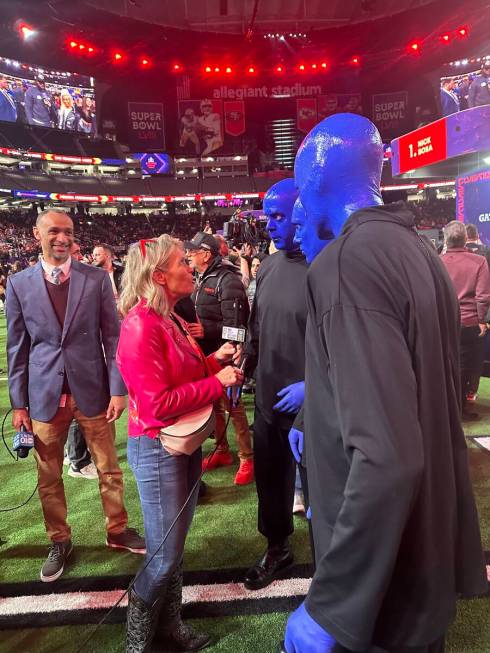 Members of the Blue Man Group are shown being interviewed during the Super Bowl Opening Night c ...