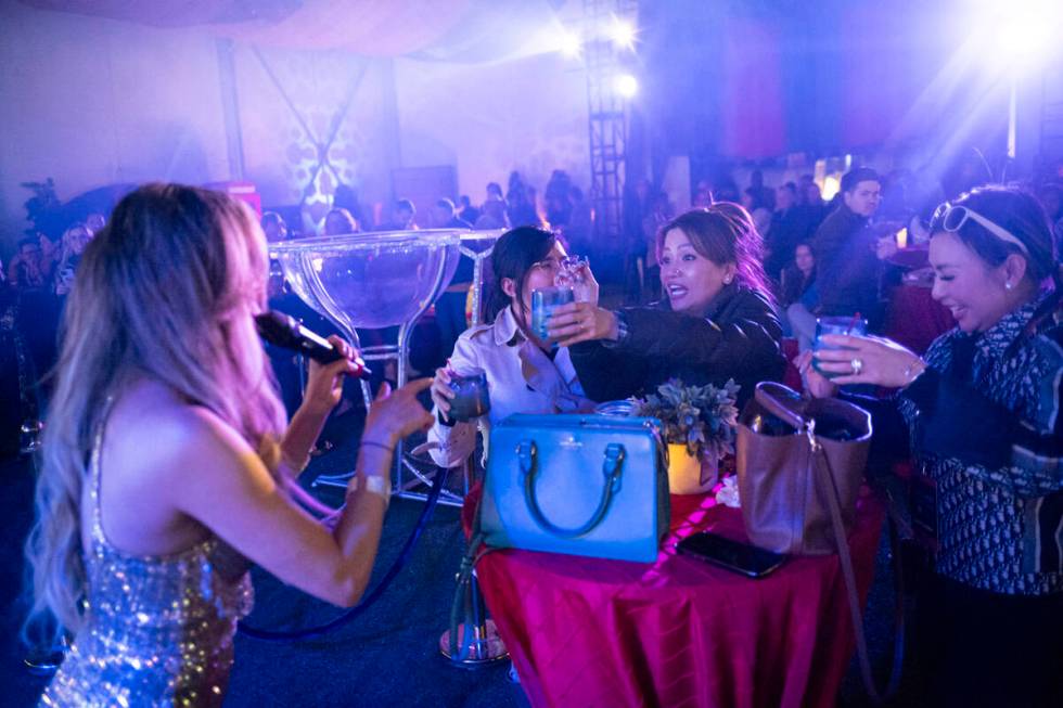 Attendees react as Lorena Peril of Fantasy performs at Frooog’s Camp House on Hacienda, outsi ...