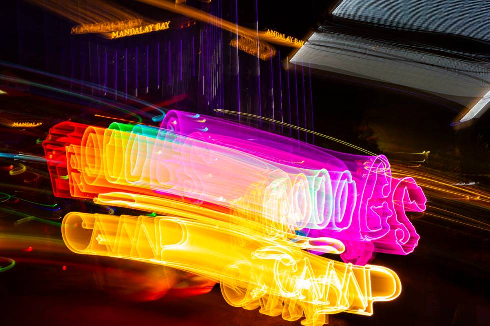 A long exposure photograph of a neon sign for Frooog’s Camp House, outside of the Luxor, on W ...