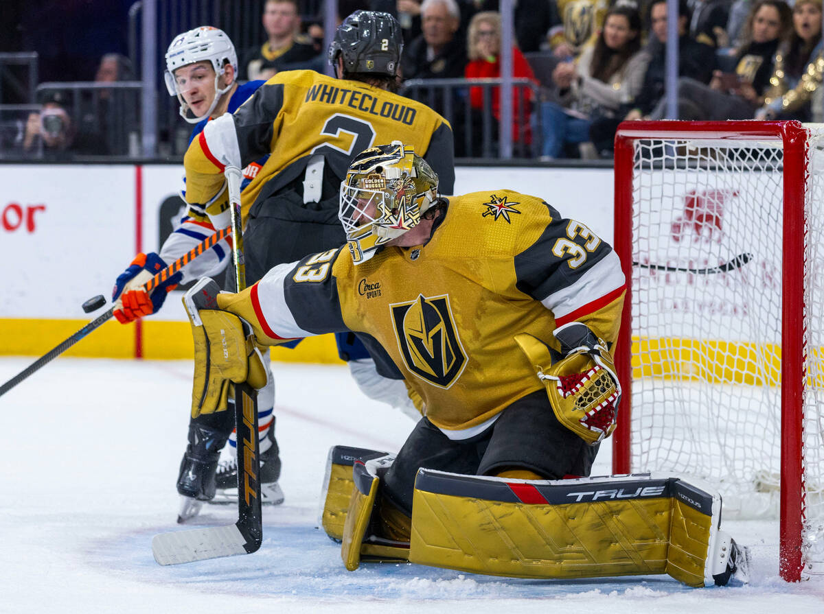 Golden Knights goaltender Adin Hill (33) deflects away another shot against the Edmonton Oilers ...