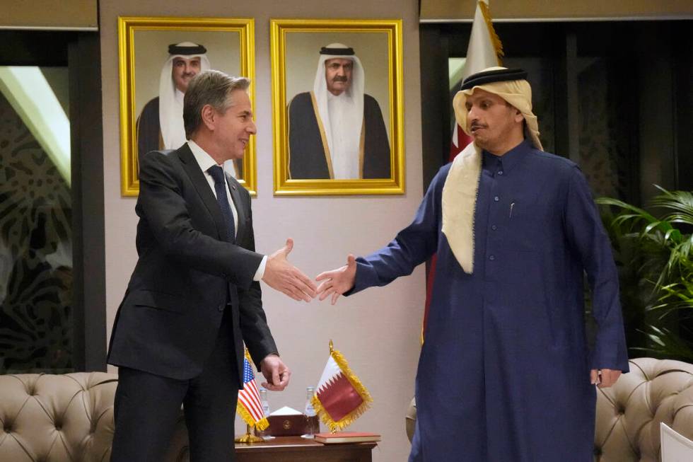 US Secretary of State Antony Blinken, left, shakes hands with Qatar's Prime Minister and Foreig ...