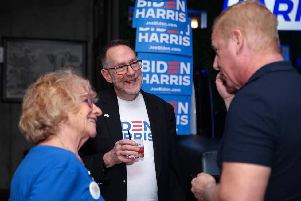Margy Feldman, left, Richard Gilroy and Steve Lane chat during a celebration for Nevada Democra ...