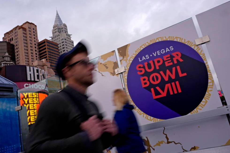 Pedestrians walk past signage for NFL Super Bowl 58 Tuesday, Feb. 6, 2024 in Las Vegas. The Kan ...