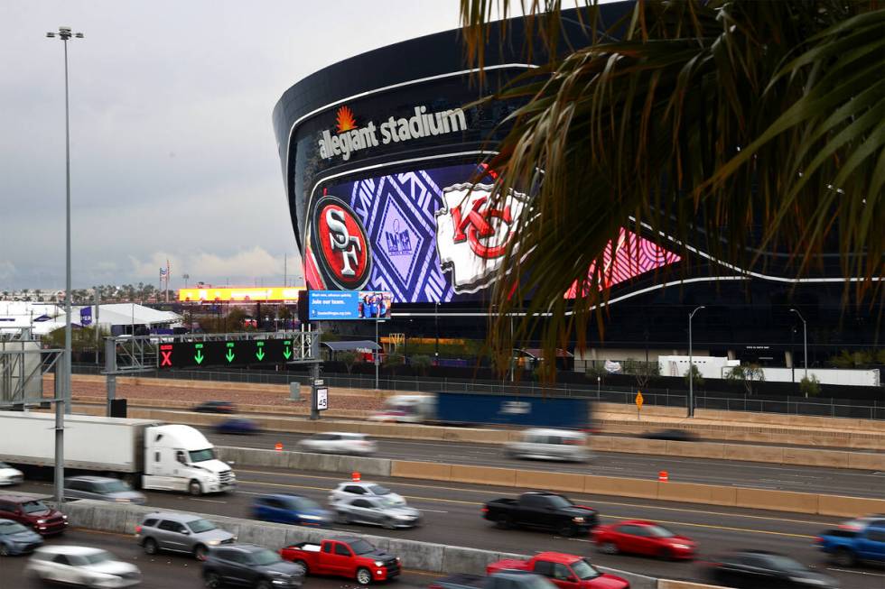 Traffic moves along I-15 past Allegiant Stadium ahead of the NFL Super Bowl 58 football game on ...