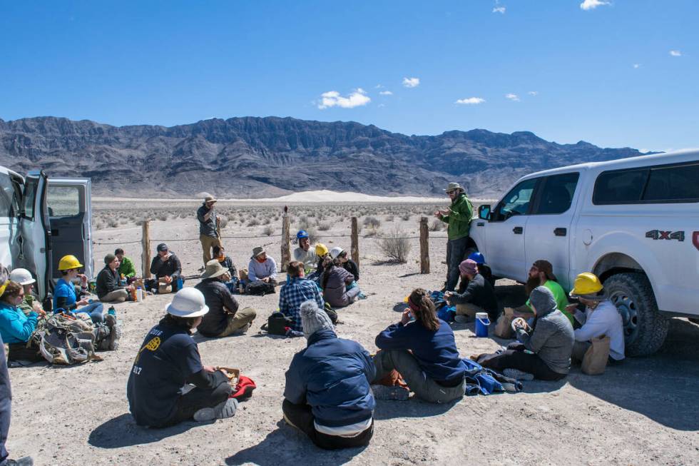 Students sit in a circle and listen to a guest speaker on an Alternative Spring Break trip. (Fr ...